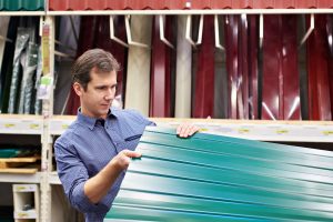 Worker looking at commercial roofing options
