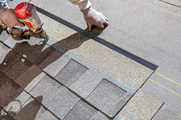 Worker Installs Composition Roofing 