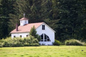 A small rural church building with a new roof