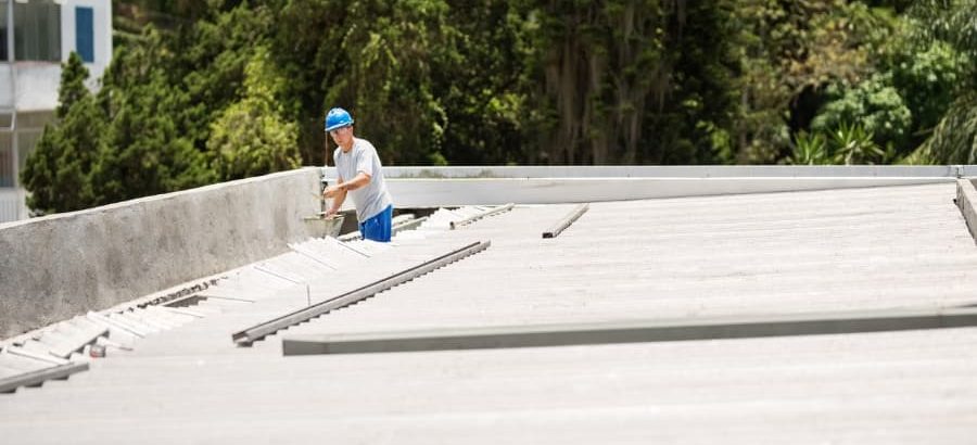 Worker repairing commercial roof