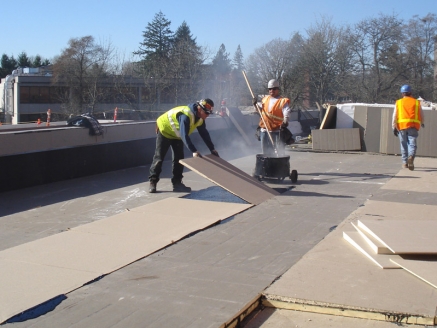 McDonald & Wetle employees install a built-up roof