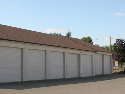 A row of attached garages with a composite roof