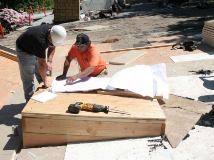 McDonald & Wetle employees work on a roof