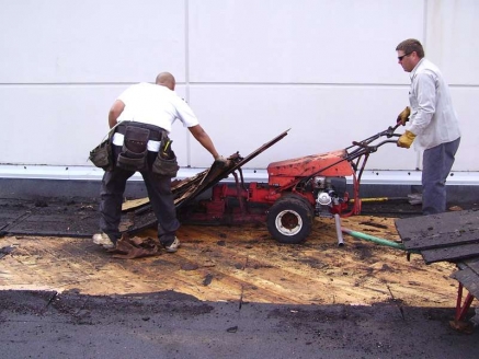 McDonald & Wetle employees repair a roof