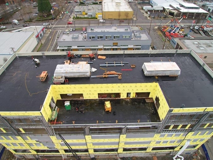 An aerial view of a high-rise commercial building with a modified built-up roof