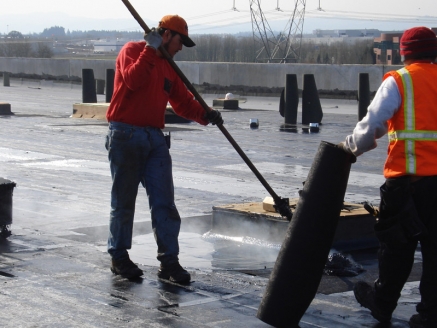 McDonald & Wetle employees install a modified built-up roof