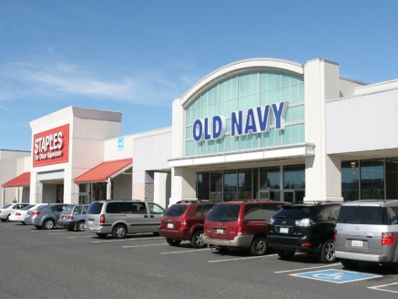 An exterior view of an Old Navy building with a Staples store nearby