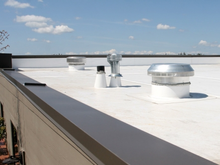 Close-up view of a completed single-ply roof on a commercial building