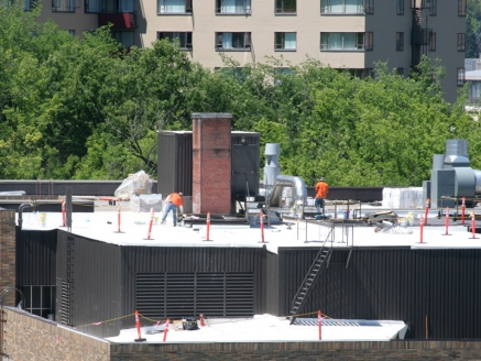 McDonald & Wetle employees install a single-ply roof on a commercial building