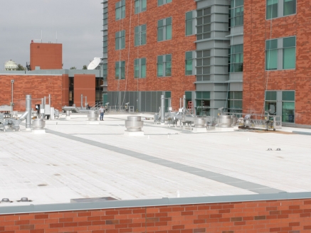 Close-up view of a completed single-ply roof on a commercial building