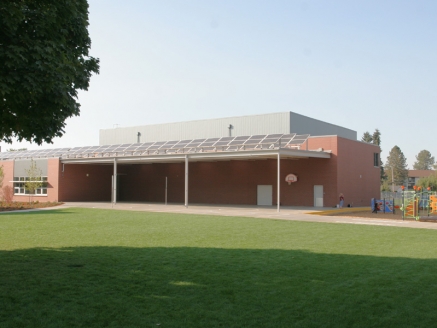 Distant view of a building with solar panels on the roof