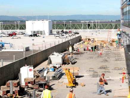 A crew works atop a waterproofed commercial building roof